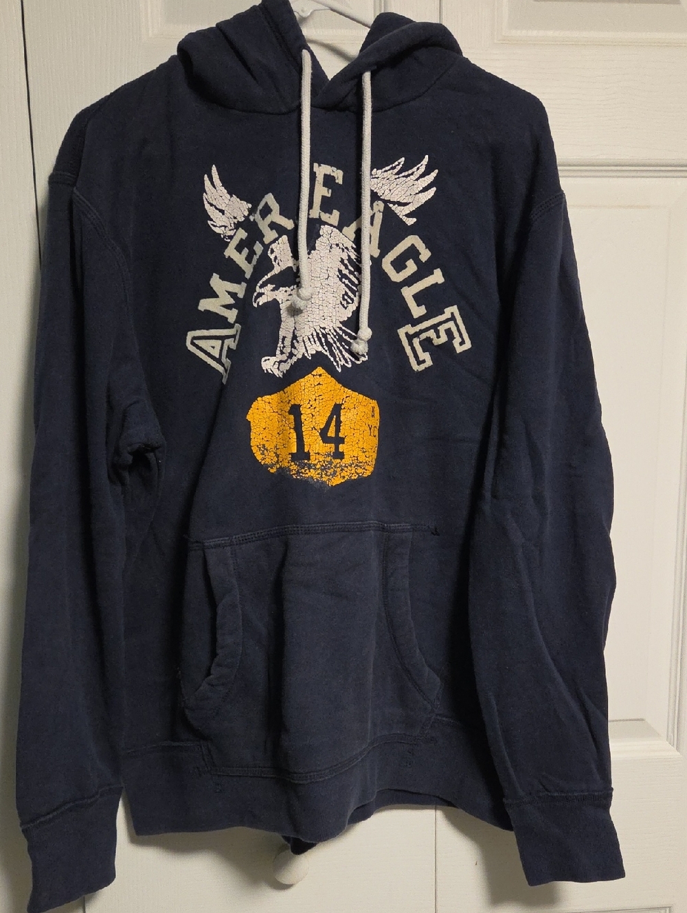 American Eagle Outfitters Navy Pullover Hoodie with Yellow Graphic